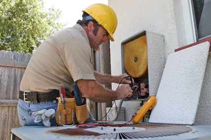 An air conditioning repairman working on a heat recovery unit