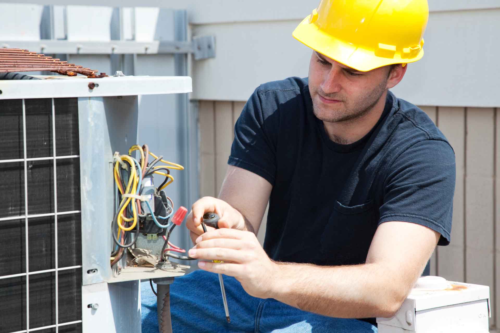 HVAC technician working on an AC unit