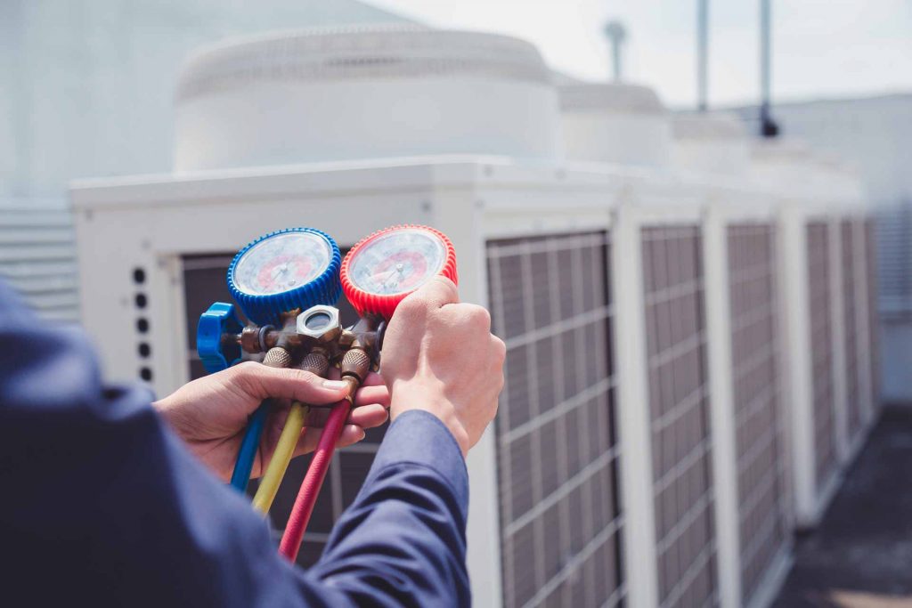 HVAC contractor checking commercial HVAC system