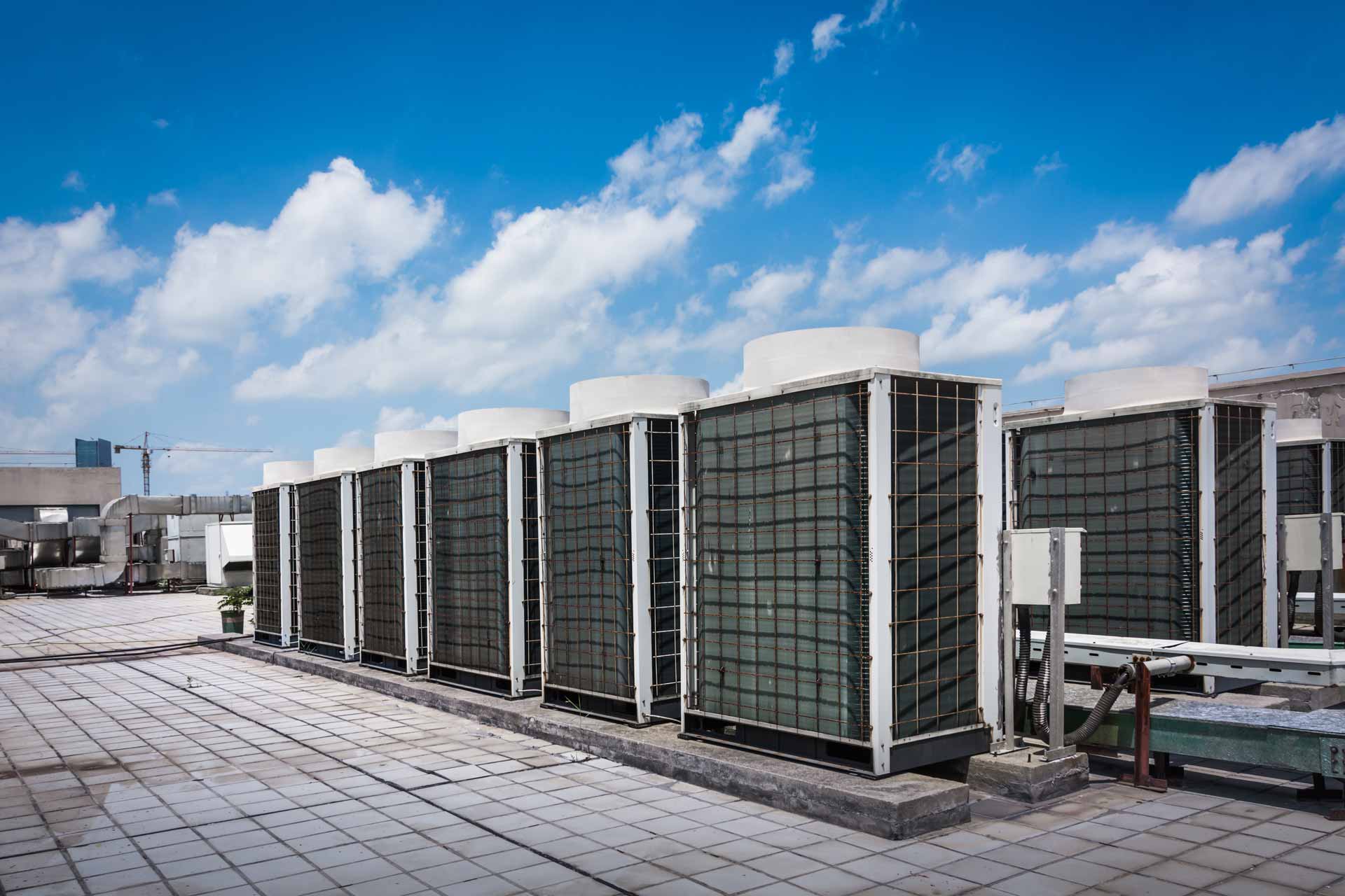 Industrial HVAC unit on roof under blue sky